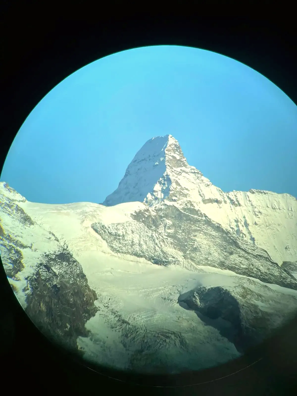 A snowy summit seen through a telescope