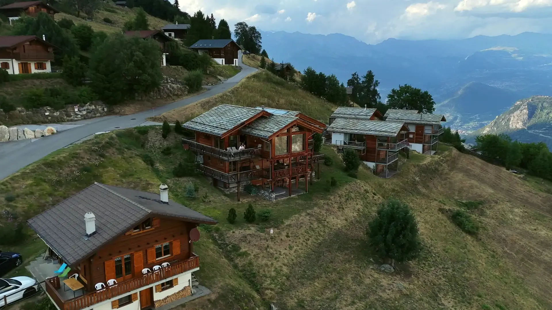 The chalet on its slope in summer, the Rhône valley below