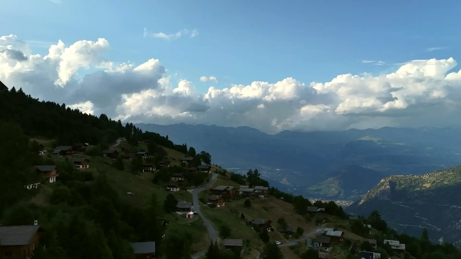 The chalet from the air on a July evening, above the valley